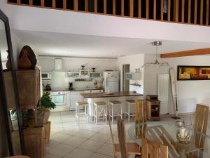 a kitchen with a dining table and a kitchen with white appliances at "L'Ancienne Etable" Dordogne in Saint-Avit-Saint-Nazaire