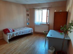 a small room with a bed and a window at Casa Adrian CAMERE CENTRU VECHI in Braşov