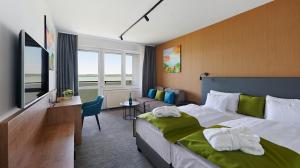 Postel nebo postele na pokoji v ubytování Hotel OTP Balatonszemes