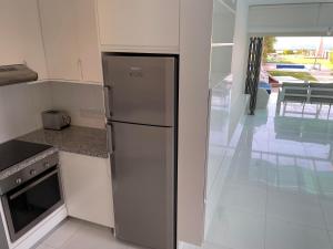 a kitchen with a stainless steel refrigerator and a stove at Ilios Akti in Lachi