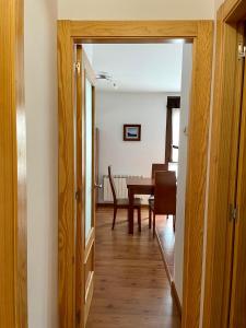 a hallway with a table and a dining room at Piso San Andrés - Picos de Europa in Carreña de Cabrales 