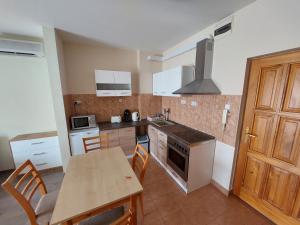 A kitchen or kitchenette at Cserke Napfény Apartman