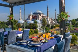 een tafel met eten erop met uitzicht op de blauwe moskee bij Aristocrat Hotel in Istanbul