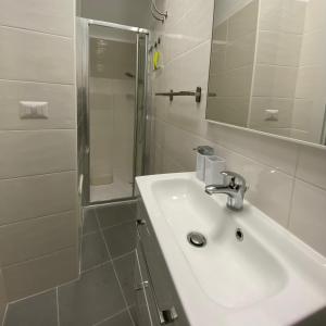 a white bathroom with a sink and a shower at Casa Vita Scilla in Scilla +21 photos
