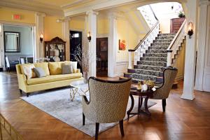 a living room with a staircase and a couch at JH Adams Inn, Trademark Collection by Wyndham in High Point