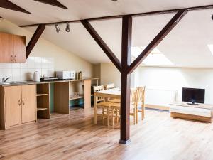 a kitchen and dining room with a table and chairs at Amber in Liepāja