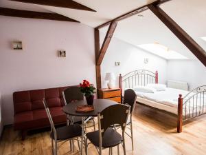 a room with a bed and a table and chairs at Amber in Liepāja
