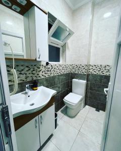 a bathroom with a toilet and a sink at HagiaSophia Donat Suites in Istanbul
