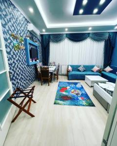 a living room with a blue couch and a table at HagiaSophia Donat Suites in Istanbul
