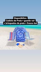 a picture of a beach with two chairs on the sand at Casa 3quartos rota Maragogi Carneiros in São José da Coroa Grande