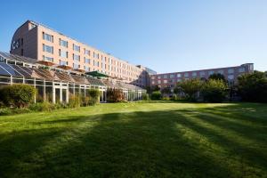 a large grass field in front of a building at co56 Hotel Chemnitz in Chemnitz