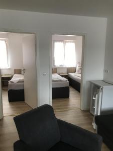 a living room with two beds and a couch at Pension Kaiser in Neuhaldensleben