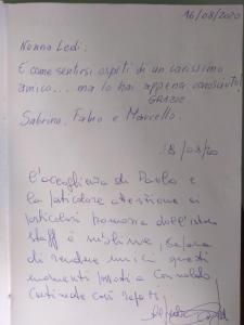 a handwritten letter with handwriting on a white paper at nonna Ledi centro storico in Corinaldo