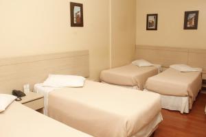
Cama ou camas em um quarto em Rio Jordao Hotel BH
