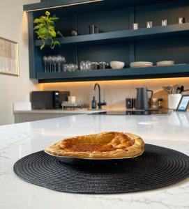 a pie sitting on a counter in a kitchen at Beautiful old bank in Bakewell in Bakewell