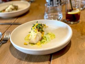 a white plate of food on a wooden table at Beautiful old bank in Bakewell in Bakewell +14 photos
