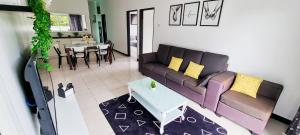 a living room with a couch and a table at 80'S PARADISE in Tanah Rata