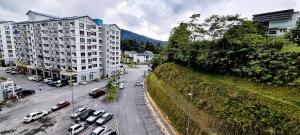 a city street with cars parked next to buildings at 80'S PARADISE in Tanah Rata