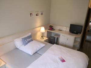 Postel nebo postele na pokoji v ubytování Hotel garni Haus am Meer