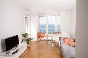 a living room with a couch and a table at Marconi 442 in Sanremo