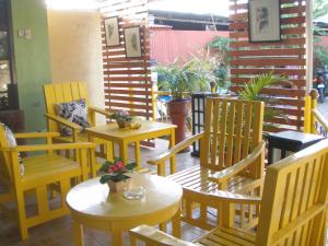 a group of tables and chairs in a restaurant at Anthurium Inn in Mactan