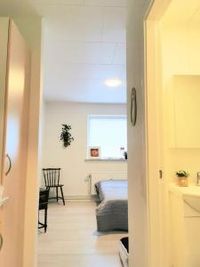 a hallway leading to a bedroom with a bed at 3 minute walk to LEGO - Best Location - n18 in Billund