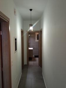 a hallway with a hallway leading to a bathroom at Seaside luxury apartment in Analipsi