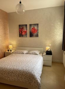 a bedroom with a bed and two paintings on the wall at Ifrane Chalet in Ifrane