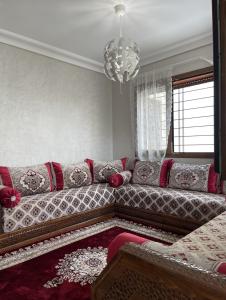 a living room with a couch and a chandelier at Ifrane Chalet in Ifrane