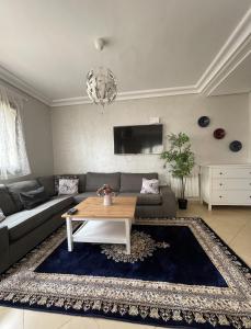 a living room with a couch and a table at Ifrane Chalet in Ifrane