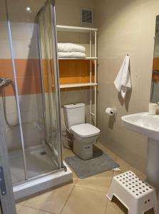a bathroom with a shower and a toilet and a sink at Ifrane Chalet in Ifrane +14 photos