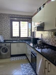 a kitchen with a sink and a dishwasher at Ifrane Chalet in Ifrane