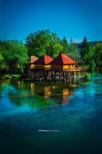 a building on a dock on the water at Natural Paradise in Bosanska Krupa
