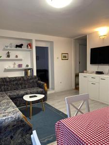 a living room with a couch and a table at apartman "MIMO" in Sarajevo +7 photos