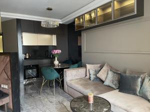 a living room with a couch and a table at Apart Elena Arcadia Sea View in Odesa