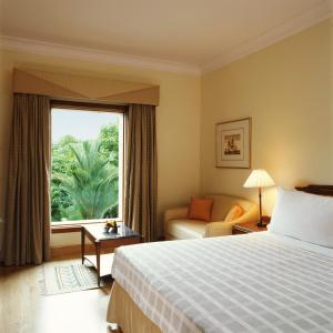 A bed or beds in a room at Trident Cochin