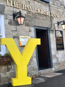 a yellow y sign in front of a building at Bay Horse Inn Goldsborough in Knaresborough