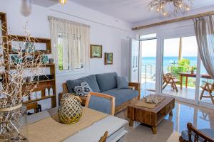 een woonkamer met een blauwe bank en een tafel bij Sul Mare in Diakopto