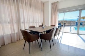a dining room with a table and chairs with a view at לביא אילת lavie eilat in Eilat