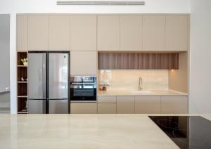 a kitchen with white cabinets and a stainless steel refrigerator at לביא אילת lavie eilat in Eilat