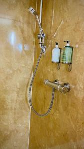 a shower in a bathroom with a shower head at Siberia Bar & Hotel in Aberdeen