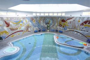 a swimming pool filled with lots of blue and white tiles at Belarus Hotel in Minsk