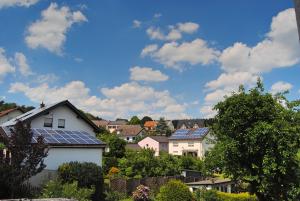 a group of houses with solar panels on their roofs at Stilvolles Eifelhaus am Nürburgring mit eigenem Garten in Boos