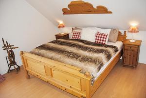 a bedroom with a wooden bed and two night stands at Stilvolles Eifelhaus am Nürburgring mit eigenem Garten in Boos