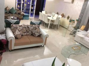 a living room with a couch and a table at Apartment Nazaha for families only in Tangier