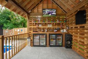a wooden cabin with a tv on the wall at Luxurious oasis relax 32c pool, jacuzzi games bar in Deal
