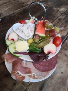 a plate with a bunch of different types of food at Hotel garni Haus am Meer in Neuharlingersiel