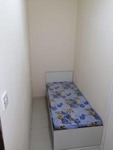 a small bed in a corner of a room at Low-Priced Budget Rooms for rent near Dubai DAFZA in Dubai
