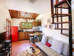 a living room with a couch and a kitchen at Pôr do Sol by LovelyStay in Calheta