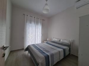 Katil atau katil-katil dalam bilik di Cosy and modern appartment in Olympiada